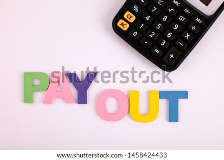 Pay Out word concept made from colored wooden letters on white table