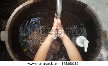 Children are washing their hands. For cleanliness after playing at the playground