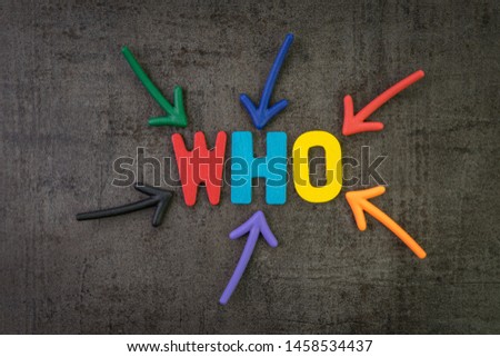 Who, business idea to ask for person or customer concept, multi color arrows pointing to the word WHO at the center of black cement chalkboard wall. Royalty-Free Stock Photo #1458534437