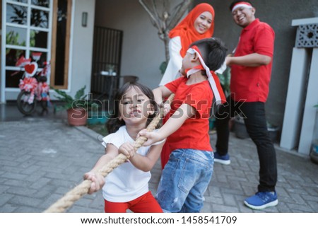 lomba tarik tambang. indonesia traditional tug of war on independence day celebration with family