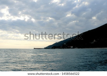 Summer calm Seascape with Mountains and Clouds without people. Sea nature travel photography similar.