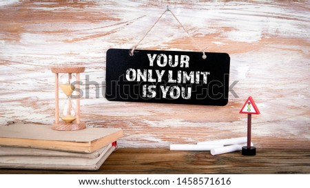 Your Only Limit Is You. Small blackboard on the wall with text, positive thinking and looking forward concept