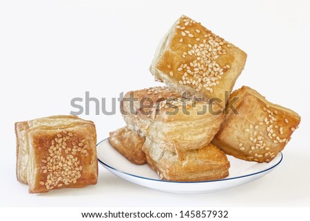 Small Square Sesame Puff Pastry Zu-Zu On Porcelain Plate Isolated On White Background With Precise Clipping Path