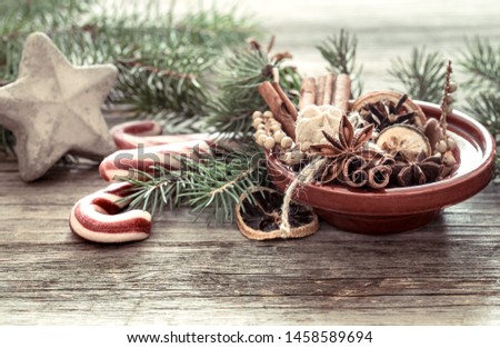 Christmas tree made out of dried oranges,cinnamon sticks and anise star with plate on wooden table