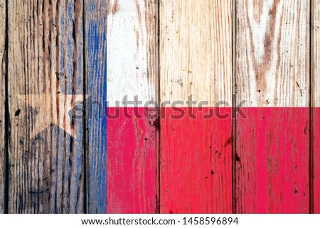Texas US state national flag on a gray wooden boards background on the day of independence in different colors of blue red and yellow. Political and religious disputes, customs and delivery.