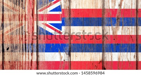 Hawaii USA state national flag on a gray wooden boards background on the day of independence in different colors of blue red and yellow. Political and religious disputes, customs and delivery.