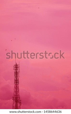 Vertical Image of Telecommunication Tower Against Dreamy Pink Cloudy Sky