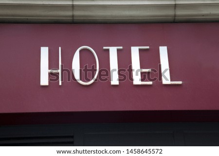 White Hotel Sign on Building Facade;