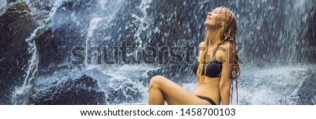 Woman traveler on a waterfall background. Ecotourism concept BANNER, LONG FORMAT