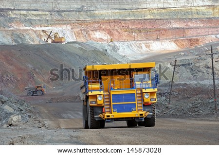 A picture of a big yellow mining trucks at work site