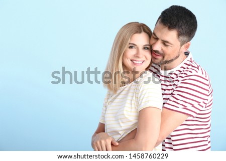 Portrait of happy couple in love on light background