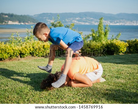 children playing leapfrog in the garden Royalty-Free Stock Photo #1458769916