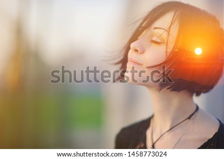 Double multiply exposure portrait of a dreamy cute woman meditating outdoors with eyes closed, combined with photograph of nature, sunrise or sunset, closeup. Psychology freedom power of mind concept Royalty-Free Stock Photo #1458773024