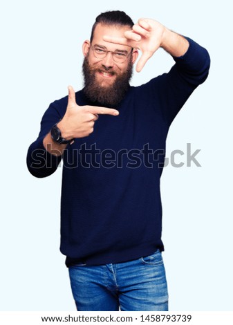 Young blond man wearing glasses and turtleneck sweater smiling making frame with hands and fingers with happy face. Creativity and photography concept.