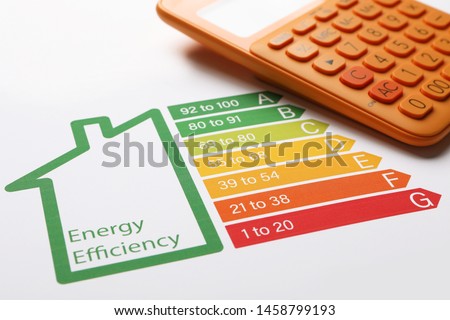Energy efficiency rating chart and calculator, closeup Royalty-Free Stock Photo #1458799193