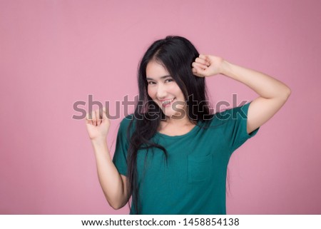 Portrait of a beautiful asian young woman on pink background. Body language, symbol, gestures, beauty and fashion concept.