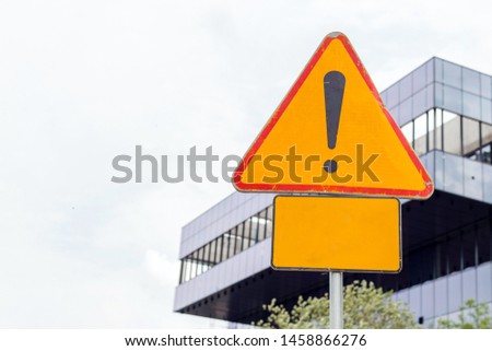 Danger ahead roadsign with blank sign to enter your text to raise attention, urban background