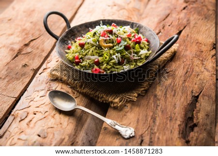 Hariyali Poha / Green Masala Pohe or flattened rice served in a bowl, selective focus
