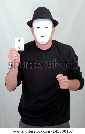 A Masked Mime Holding 2 of Spades on a Gray Background