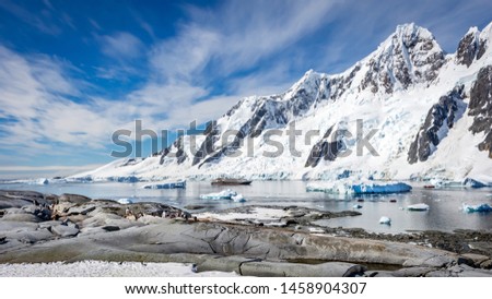 Group of  Penguins , Expedition cruise ship and Antarctic landscape background, sunny day, wide format