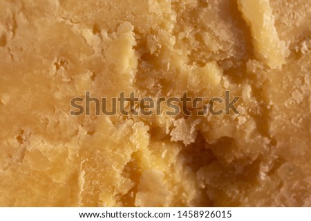 Italian Parmesan Cheese. cheese surface close-up. yellow abstract food background