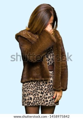 Beautiful middle age elegant woman wearing mink coat tired rubbing nose and eyes feeling fatigue and headache. Stress and frustration concept.