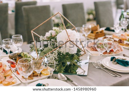 Beautiful wedding restaurant for marriage. White decor for bride and groom. Colorful decoration for celebration. Beauty bridal interior. Bouquet and flowers in hall