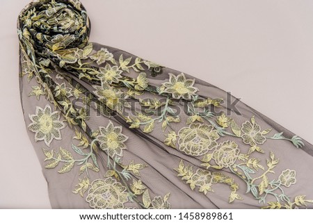 Texture lace fabric. lace on white background studio. thin fabric made of yarn or thread. a background image of ivory-colored lace cloth. Green and yellow lace on beige background.