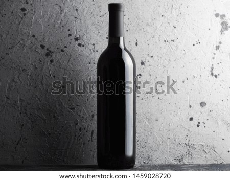 Bottle of wine on grey concrete background copy space