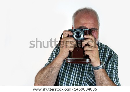 Typical, old, sweaty tourist from Germany with red head photographed with his equally old photo camera.