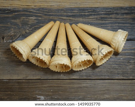 Cone - 
 ice cream with empty cones on the wooden  background -  top view