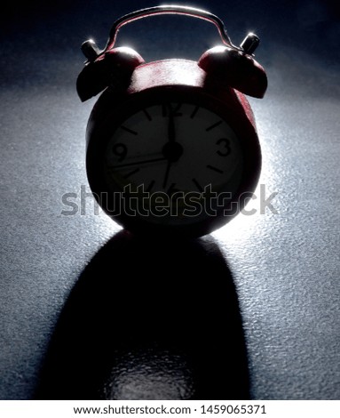 
striking clock on black background
