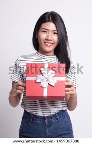 Young Asian woman with a gift box on white background