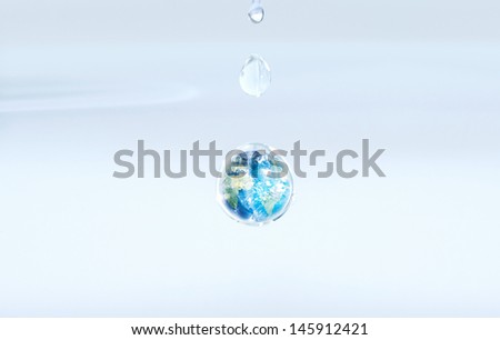 Digitally composed image of planet earth inside a drop of water representing misuse and wastage of natural resources.