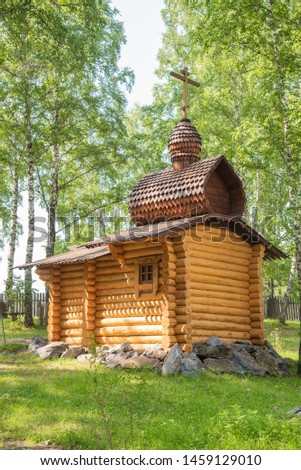 Wooden christian chapel in the forest, Siberia, Russia.