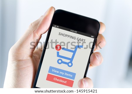 Men hand holding modern mobile phone with online shopping application on a screen.  Royalty-Free Stock Photo #145915421