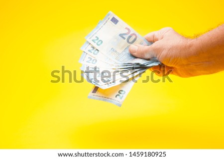 Money bills in a person's hand. Many euros of legal tender. Europe currency. Action to buy or sell something or some service. Show money as a sign of wealth.
