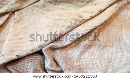Dirty cloth. Rough dirty cloth. Fabric surface. Abstract background. Folds of matter