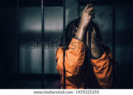 Portrait of women desperate to catch the iron prison,prisoner concept,thailand people,Hope to be free,If the violate the law would be arrested and jailed. Royalty-Free Stock Photo #1459225292