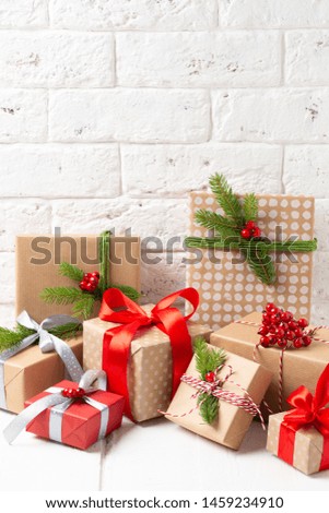 Christmas decorated gift boxes on white wooden background with copy space