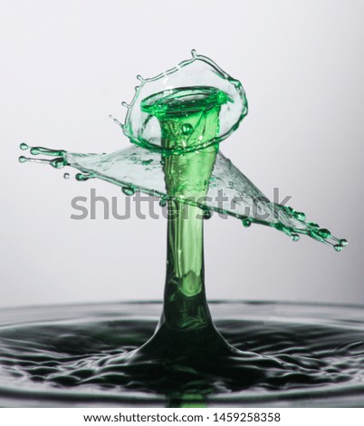 This is a high speed photograph of 2 water drops colliding