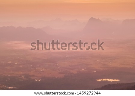 Mountain view morning of top hill around with soft fog and yellow sun light in the sky background, sunrise at Nok Aen Cliff, Phu Krakueng National Park, Loei, Thailand.