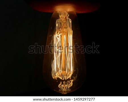 Light bulb in the dark with yellow and orange flares