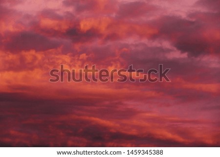 Abstract blur beautiful sunset sky above clouds with dramatic light. Red, orange and pink colors, copy space.