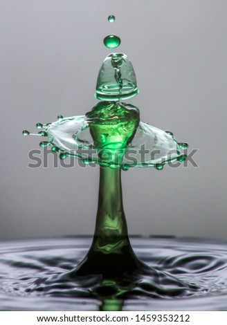 This is a high speed photograph of 2 water drops colliding