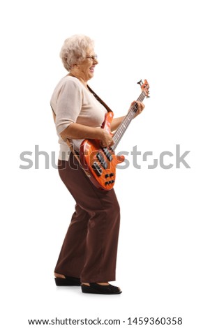 Full length shot of a senior lady playing an electric guitar isolated on white background