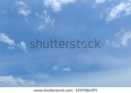Beautiful white fluffy clouds in blue sky for background picture.