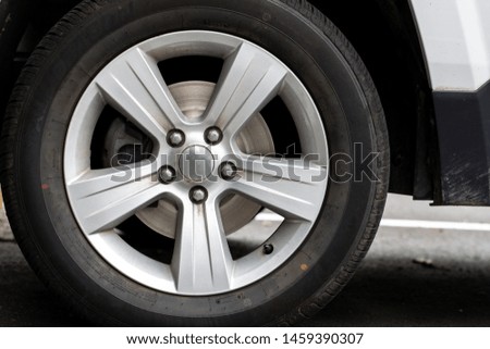 Car or SUV with silver rims, wheels, tires 