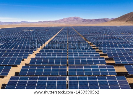 Aerial view of hundreds solar energy modules or panels rows along the dry lands at Atacama Desert, Chile. Huge Photovoltaic PV Plant in the middle of the desert from an aerial drone point of view Royalty-Free Stock Photo #1459390562