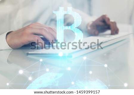 Crypto currency theme hologram with businessman working on computer on background. Concept of blockchain. Multi exposure.